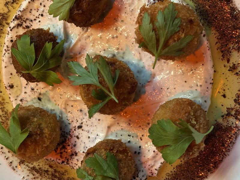 Olives wrapped in merquez breaded and deep-fried like little scotch eggs.