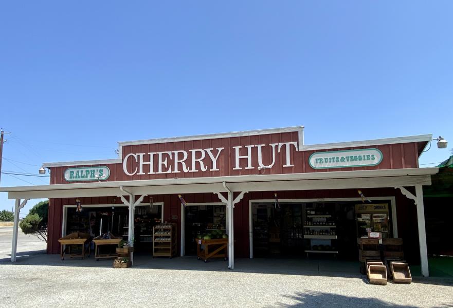 a red with white trim fruit stand