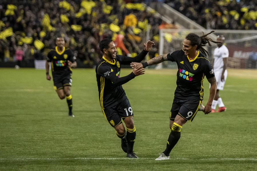 Two players from NM United high five