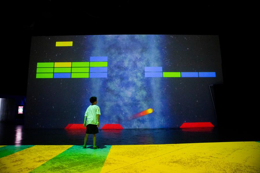 A young boy plays a game at Electric Playhouse