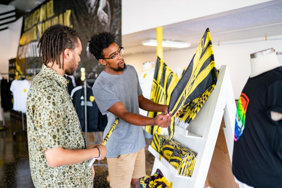 Two men shopping in the New Mexico United store