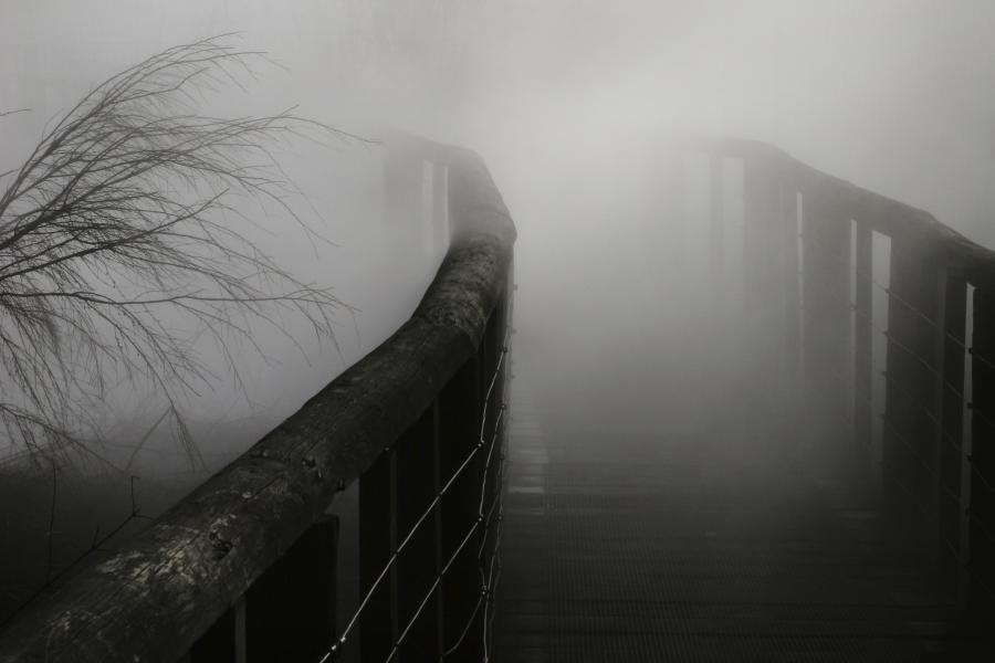 Black bridge with fog over it