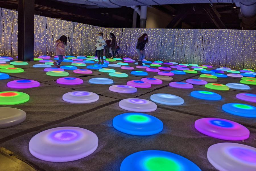 Photo of children on light up dots at Luminova