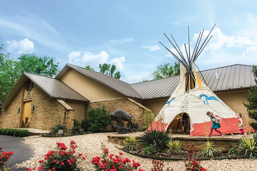 Exterior image of the Museum of Native American History. The focal point is on the giant TP in the front lawn