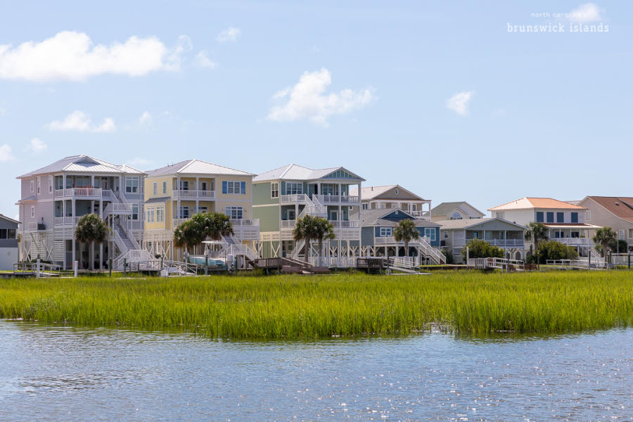 a line of colorful homes along a body of water