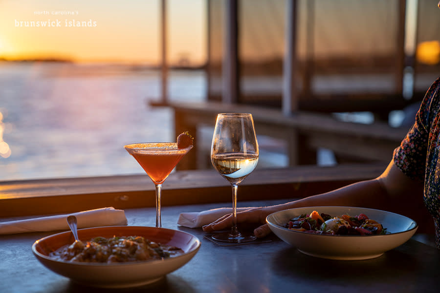 up close view of two plates of food and drinks at a waterfront restaurant