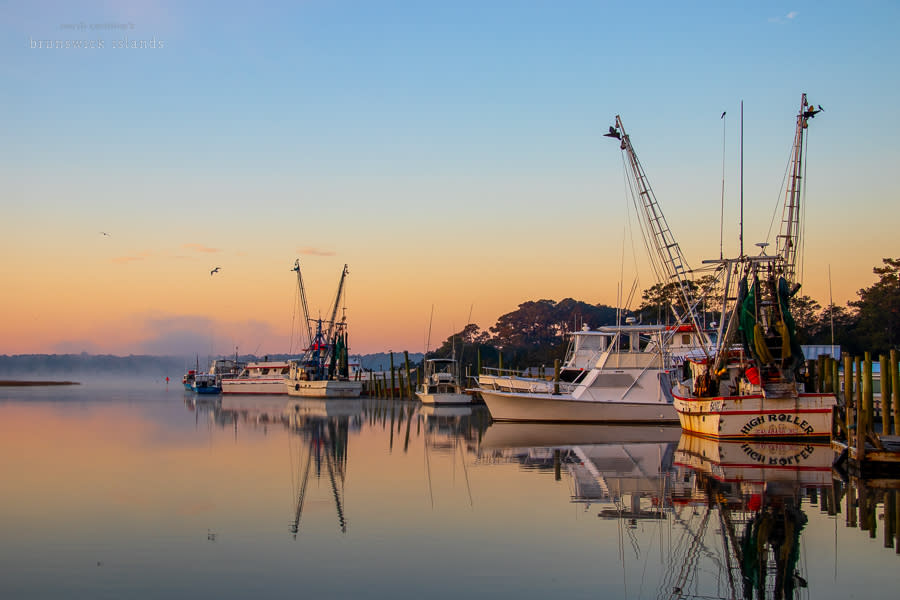 a vividly colored morning sky over Calabash waterfront
