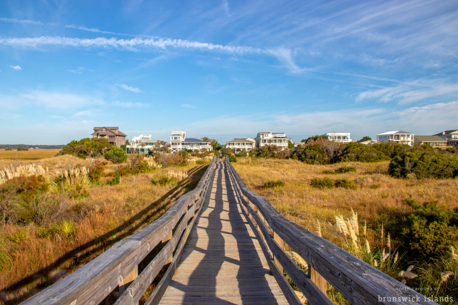 Wood walkway leading to houses near the beach