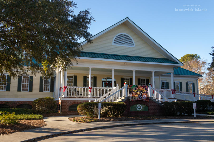 yellow golf course clubhouse with a large front porch