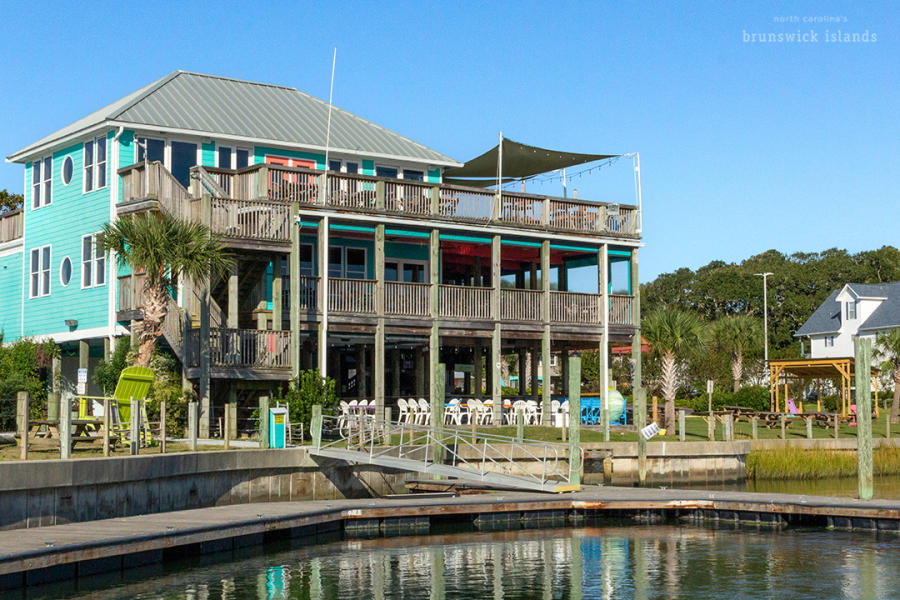 a bright turquoise building along water