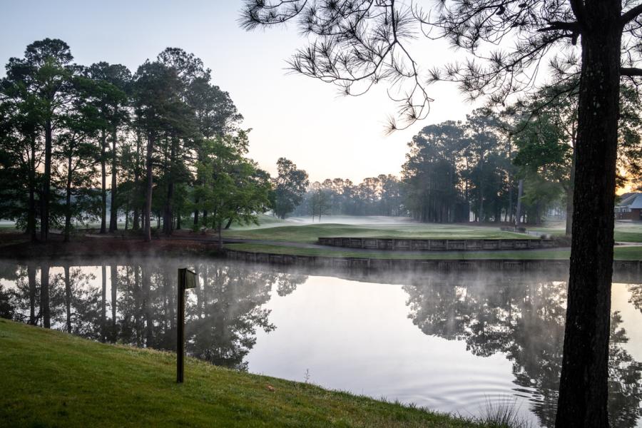 fog rising from a water trap on a golf course