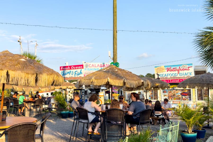 a group of people eating at outdoor tables
