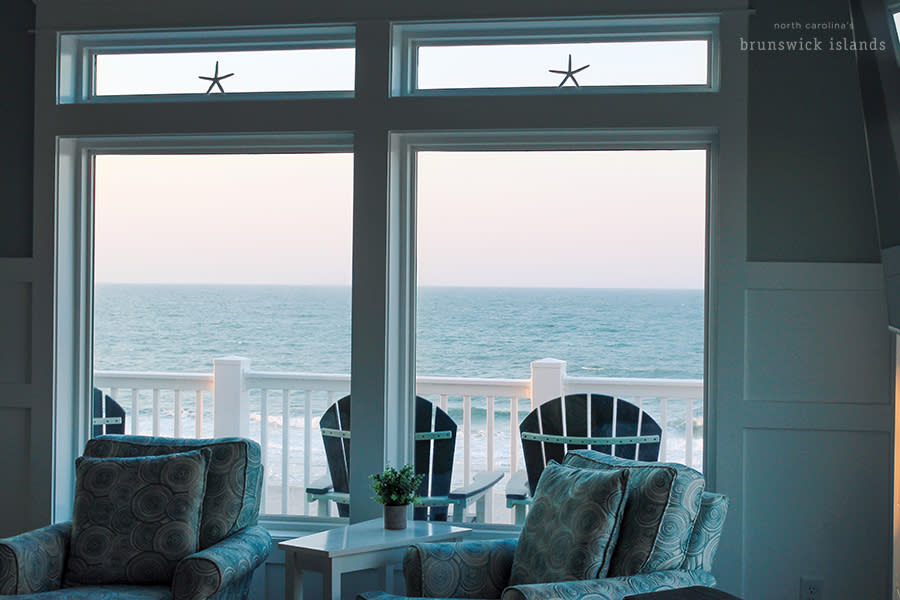 the ocean visible through the window of a vacation rental home