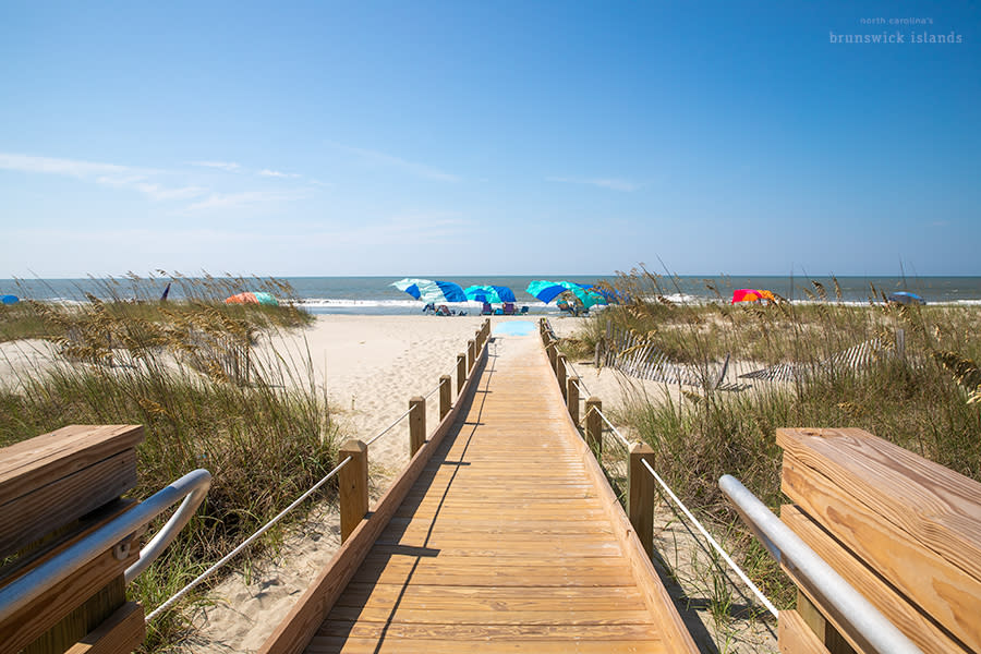 a wooden ramp extending onto the beach on Holden Beach, NC