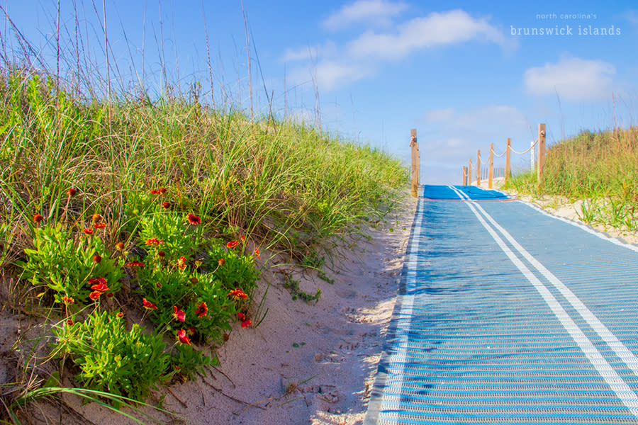 a blue mat extending over sand at a beach access on Oak Island, NC
