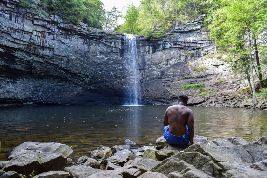 Man sits in front of Foster Falls by Ryan Maum