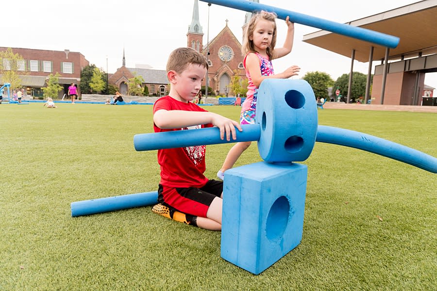 boy and girl play with large foam blocks