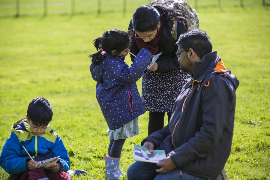 A family completing Easter worksheets at Dyrham Park