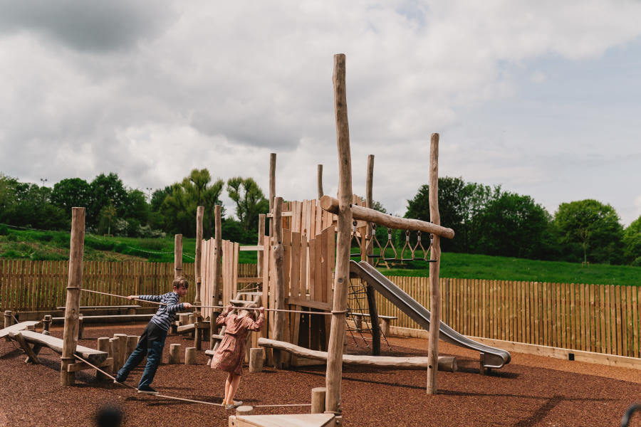 Children playing on a wooden play structure