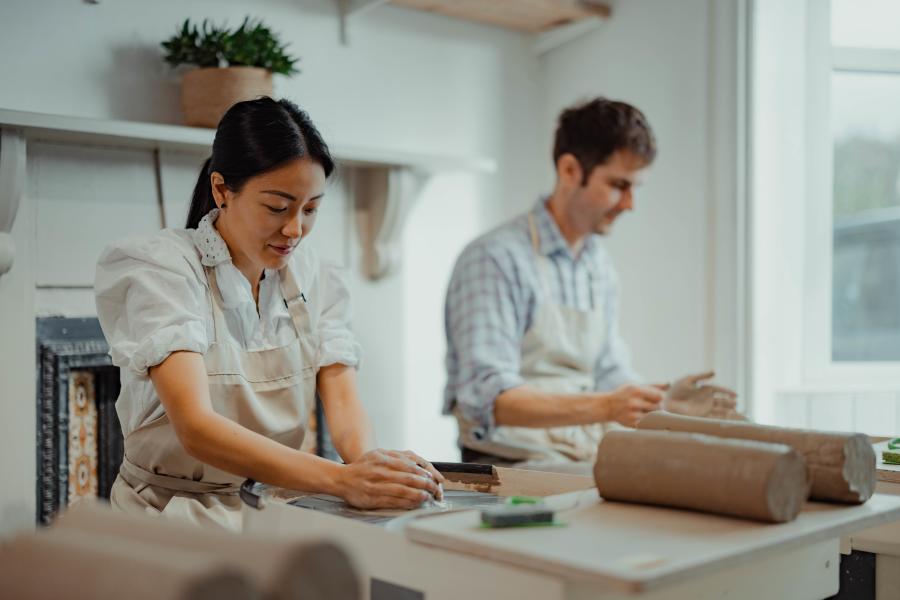 A couple throwing pots at Honeybourne Pottery
