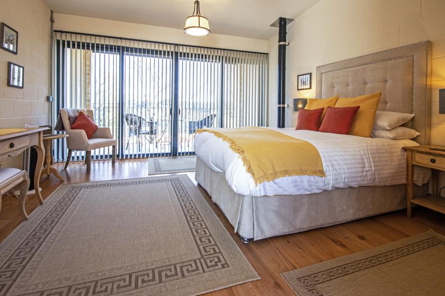 A bright and airy bedroom with patio doors opening onto a private patio