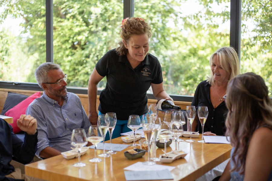 A group of people enjoying wine tasting at Woodchester Valley Vineyard