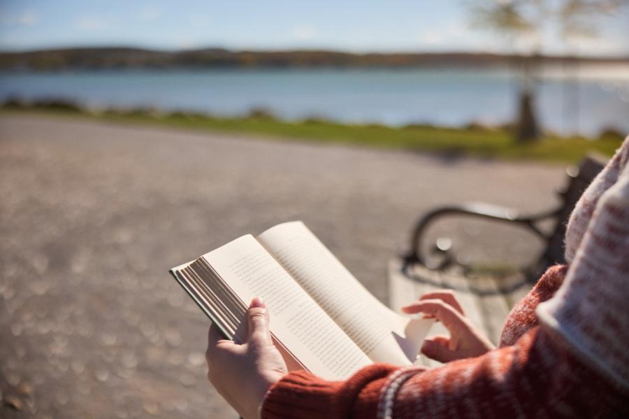 Woman reading a book at Kershaw Park in Canandaigua
