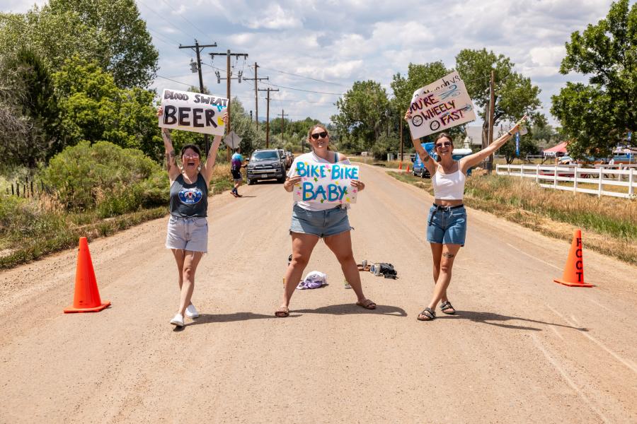 Fans with signs supporting bikes