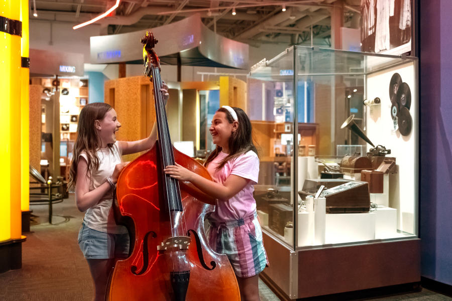 Two girls play music at the Museum of Discovery