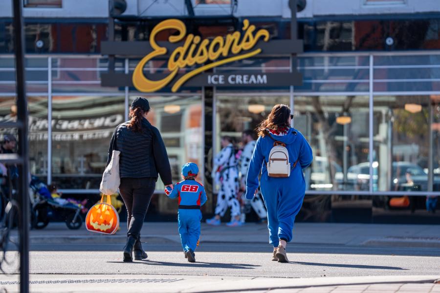 A children in walking with their parents during Tiny Tot Halloween.