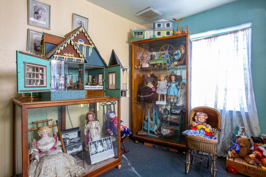 Dolls and toys in cases and on display