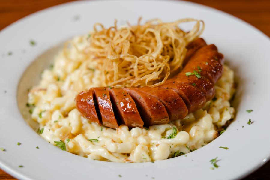 German food (spaetzle and sausage) on a plate