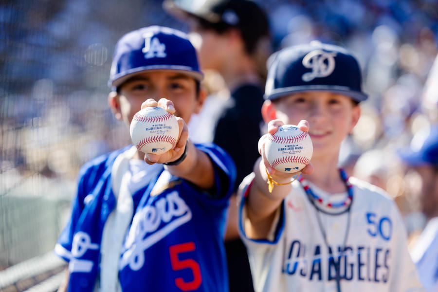 Two boys holding baseballs