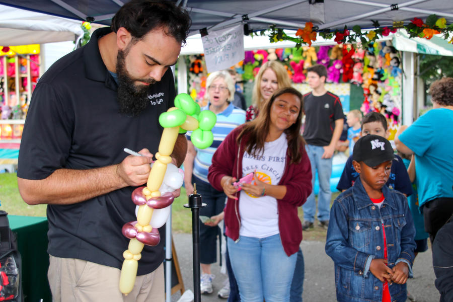 man making balloon animals for kids