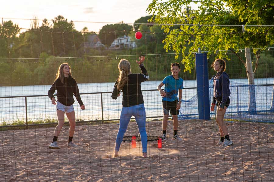 Kids play volleyball at Chutes and Ladders park in Houghton