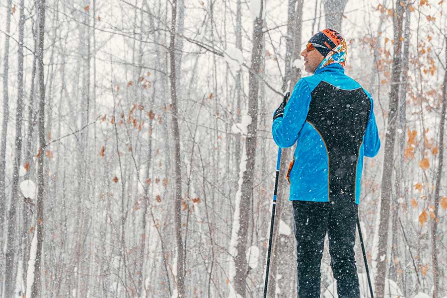 Man admires snowfall during a cross country ski outing