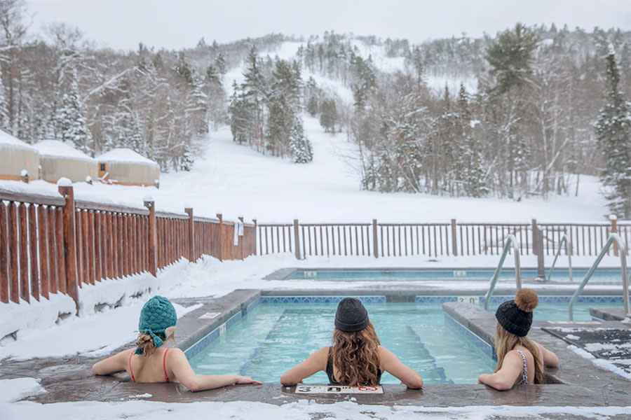 Three women relax at the nordic spa at Mount Bohemia