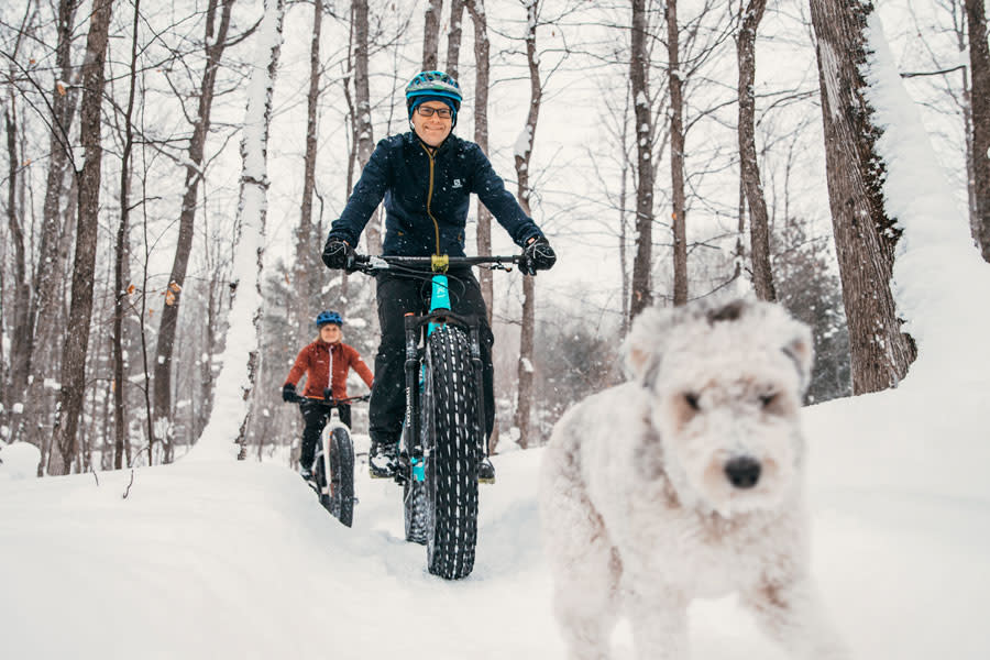 Couple with dog fat-tire biking at Swedetown.