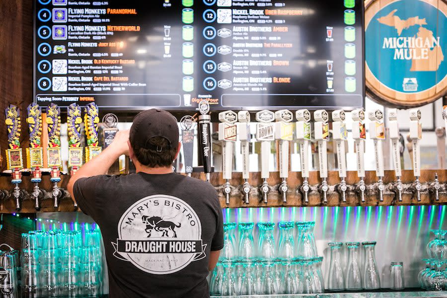 A bartender pours a beer from one of the many taps at Mary’s Bistro Draught House on Mackinac Island