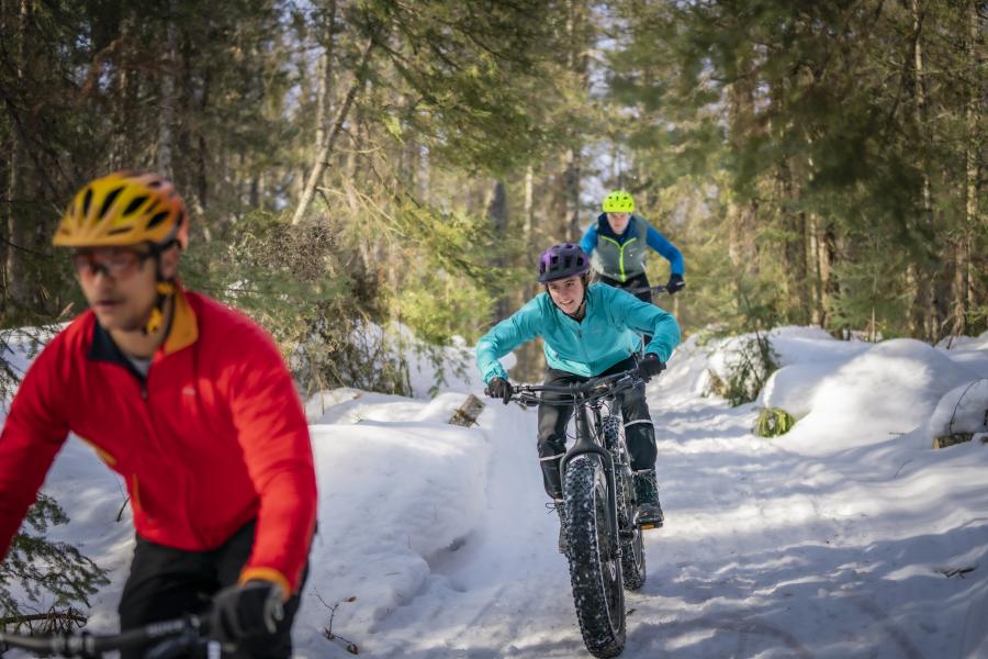 A group of friends snow biking near Marquette, MI