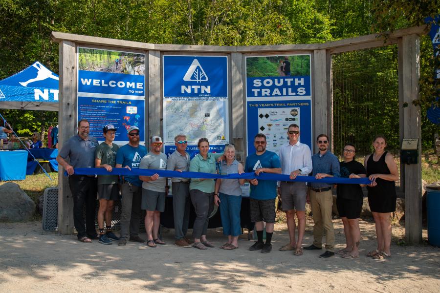 A photo from the ribbon cutting for the new "Raging River" Trail on the Noquemanon Trail Network