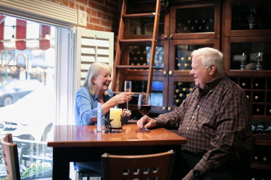 Senior couple sitting at a table in the winery