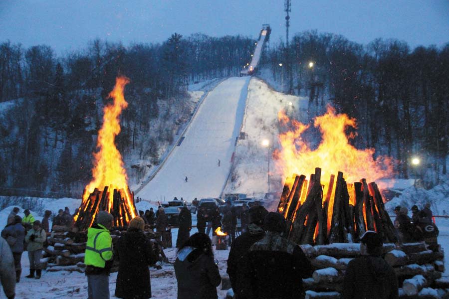 Suicide Bowl Ski Jump event with fire and the ski jump in the background