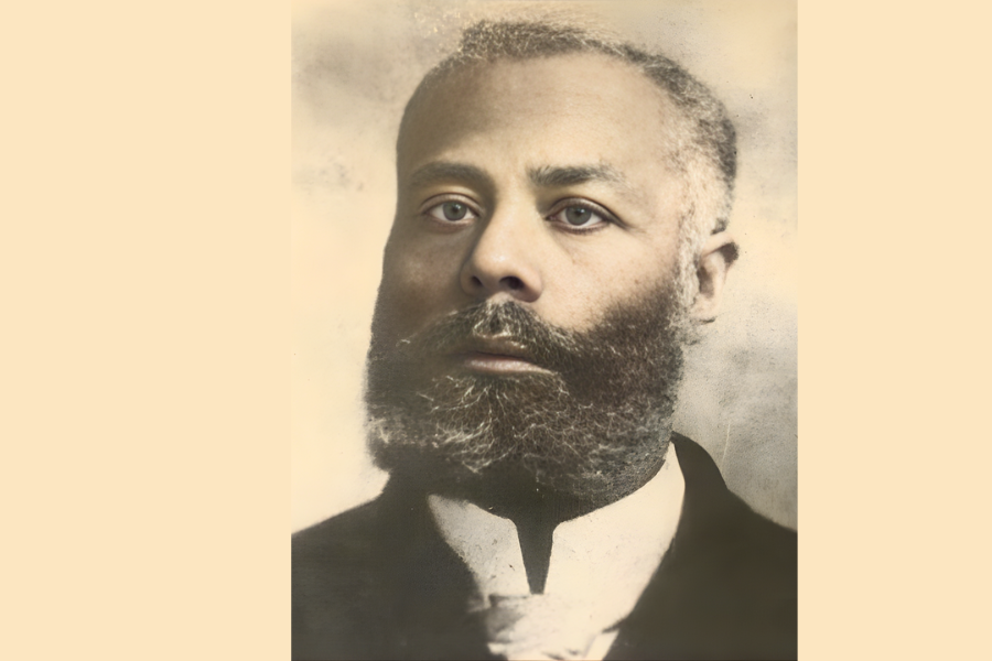 Portrait of a serious man with a full beard and short hair, wearing a dark suit and white shirt. The background is soft beige, adding a vintage feel.