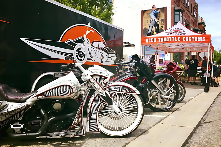 two motorcylces lined up on road for Muskegon Bike Time Rebel Road, a popup tent is in the background