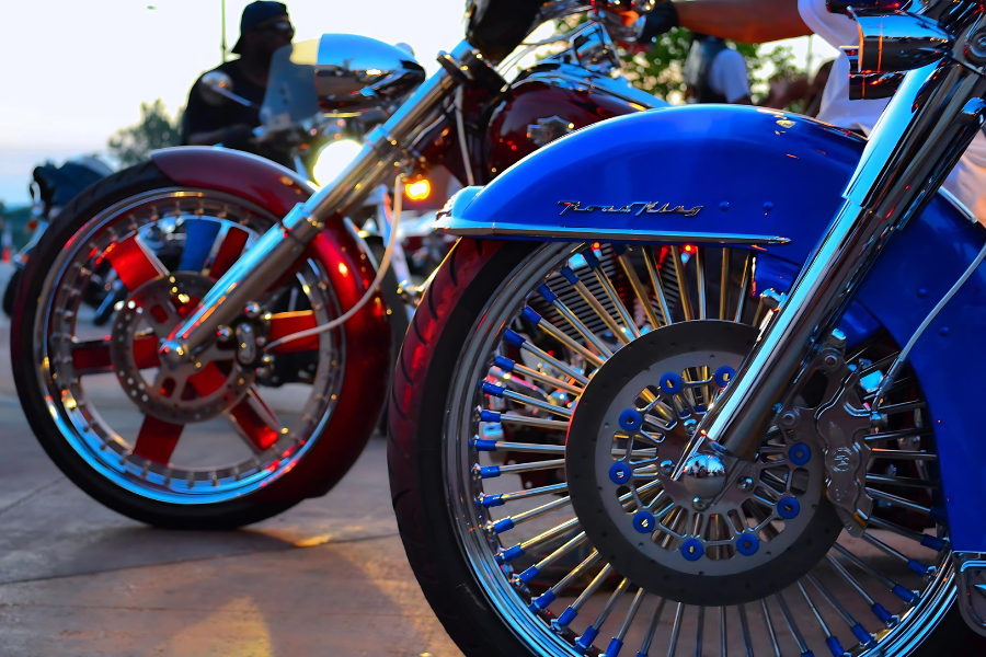 front wheels of blue harley davison (in foreground) and red motorcycle