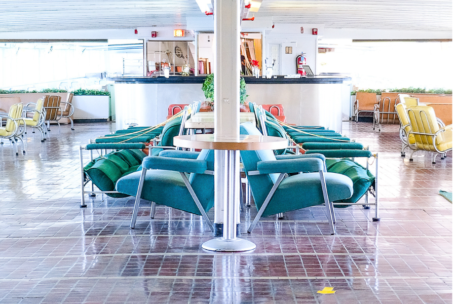 art deco style McArthur chairs with auqa color cushions lined up on lounge area of Milwaukee Clipper Lounge