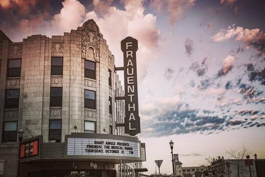 Exterior view of the historic Frauenthal Theater marquee under a cloudy sky at dusk.