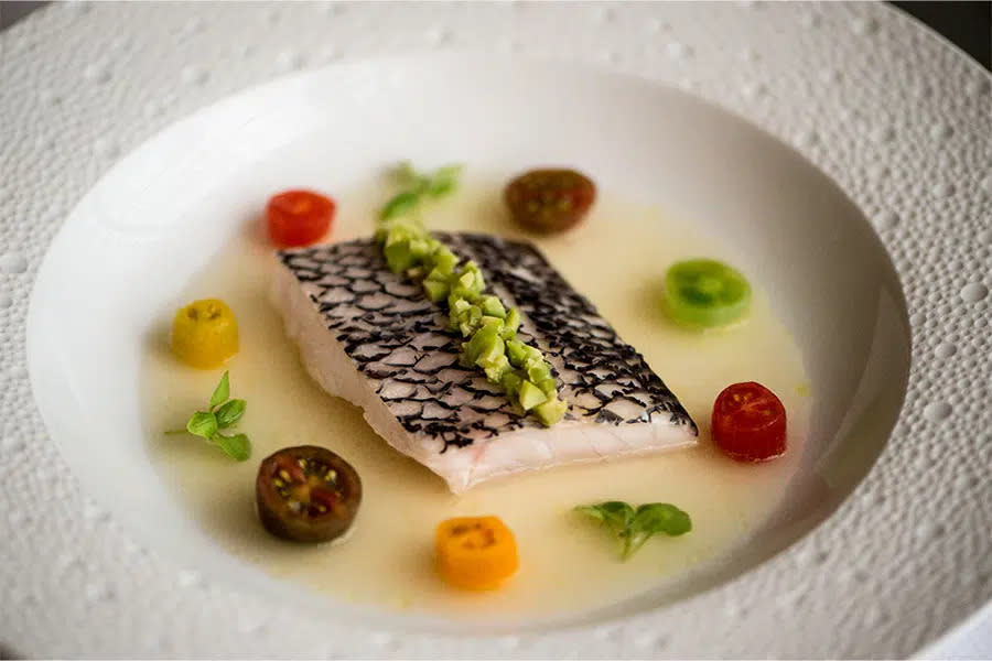 Steamed Black Bass with Marinated Heirloom Tomatoes Spiced Basil-Verbena-Tomato Consommé at Le Bernardin