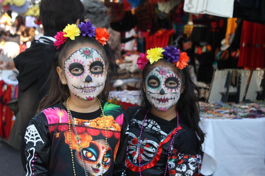 Little girls showing off their face paint at dia de los muertos festival in Oakland California